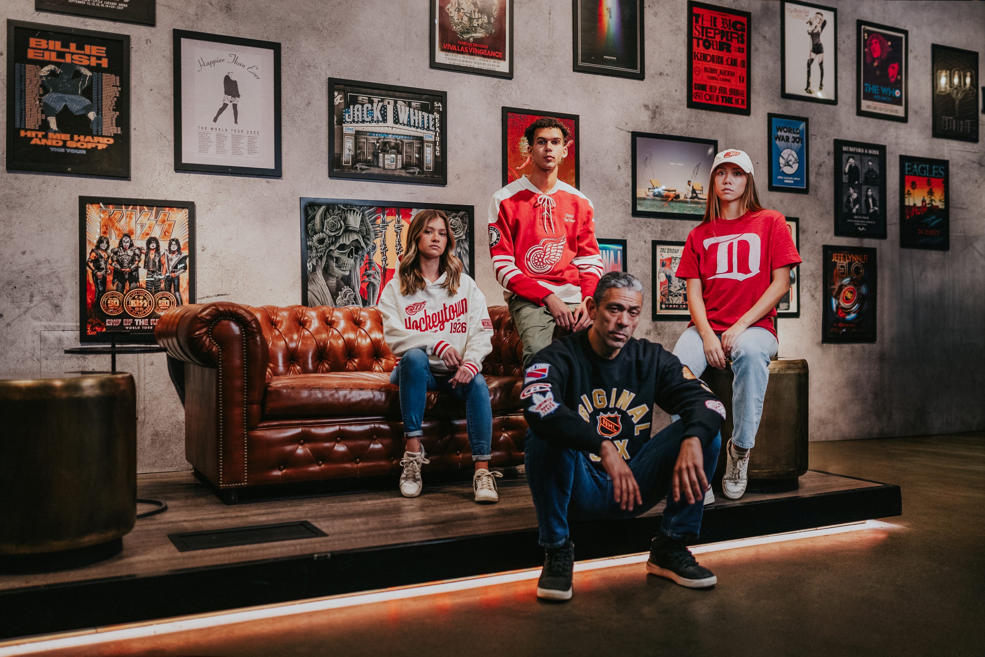 Four young adults modeling new Eras apparel, showcasing products made specifically for the cenntennial season data-size=