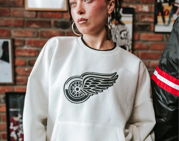Woman smiling while wearing Columbus Blue Jacket gear