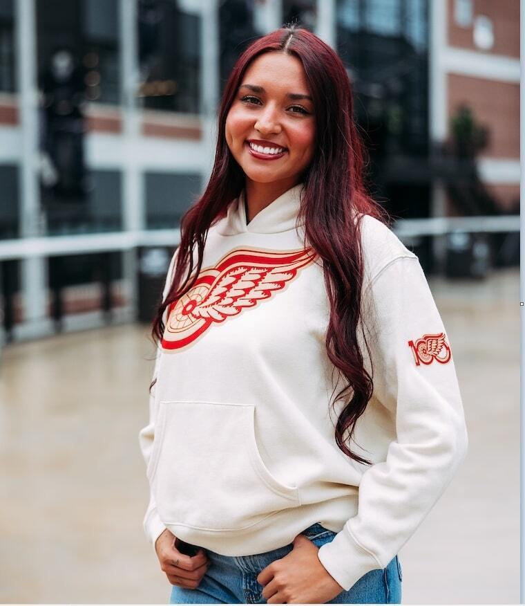 Woman smiling while wearing Columbus Blue Jacket gear