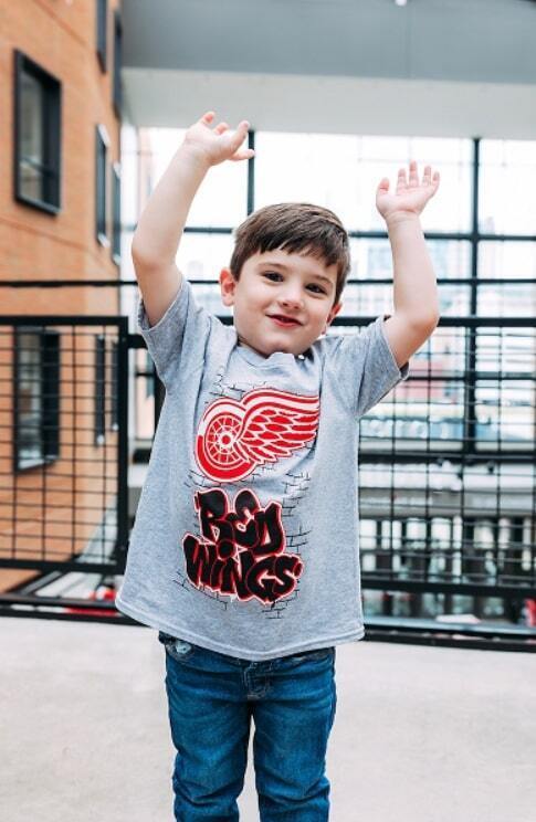 Baby smiling while wearing Columbus Blue Jacket gear