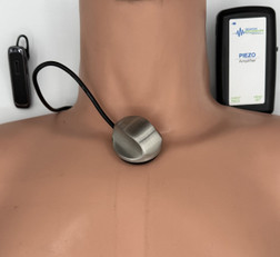 The piezo goes near the throat and your earpiece can pick this up from another room!