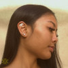 A woman wearing the gold Mayari Ear Cuff by Kapwa Kultura on her right ear. The stainless steel ear cuff features a radiant crescent-inspired design honoring Mayari, the Filipino moon goddess, symbolizing beauty, balance, and feminine strength. A stylish, no-piercing accessory that blends Filipino heritage with modern elegance.