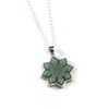 Liwanag jade necklace in a Filipino sun design on a sterling silver chain, product photo on a white background