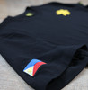 Close-up of the right sleeve of the Kapwa Legacy Tee featuring an embroidered Philippine flag patch. Premium Filipino streetwear T-shirt crafted from 100% ring-spun cotton with 240 GSM heavyweight pre-shrunk fabric and quality embroidered detailing.