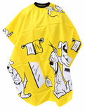 Bright yellow kids hairdressing cape with playful black and white cartoon print for haircuts and trims.
