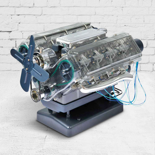 A completed model V8 engine with a transparent plastic casing, revealing the pistons and belts, standing on a display plinth.
