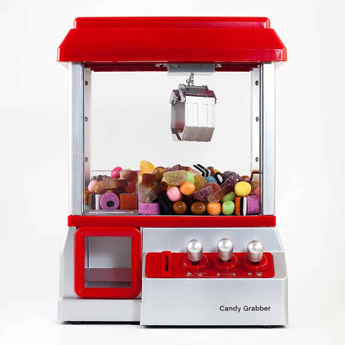 A red and silver Candy Grabber machine, its clear prize box filled with assorted colourful sweets below the metal claw.