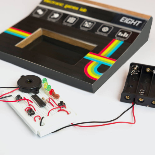 An assembled breadboard circuit with lights, ready to be placed inside the retro-styled electronic games console.