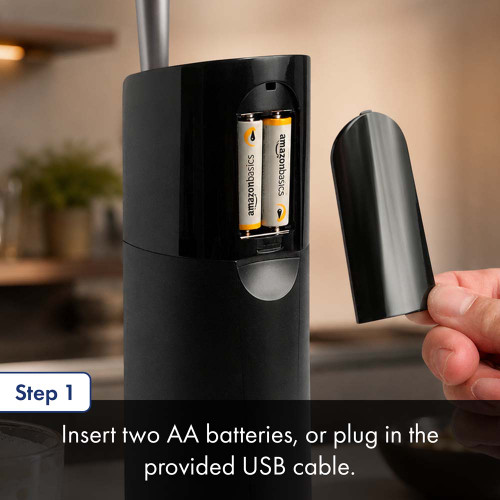 A person uses the battery compartment on a black countertop draft beer dispenser. The text below details step two about battery and USB operation.