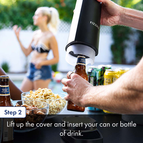 A person uses an outdoor countertop draft beer dispenser to insert a bottle of beer at a table set with snacks, including chips and salsa, while another person stands nearby. The text below details step two about lifting up the cover and inserting a drink can or bottle.