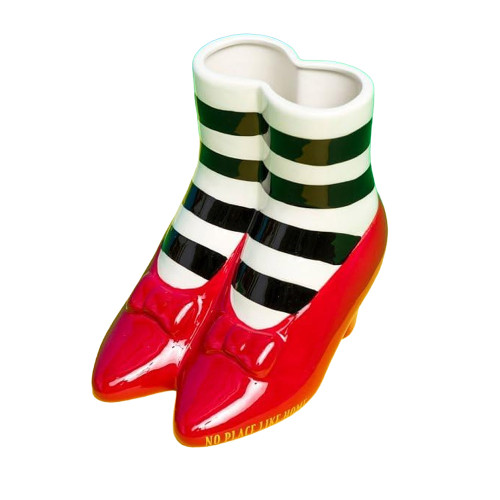 A Wizard of Oz tabletop vase shaped like red slippers and striped socks, with 'No Place Like Home' inscribed on the base.