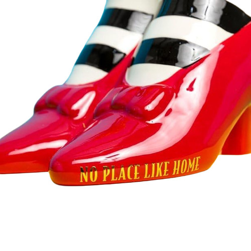 A close-up of the Red Slippers tabletop vase, focusing on the glossy red shoe with gold text reading "No Place Like Home."