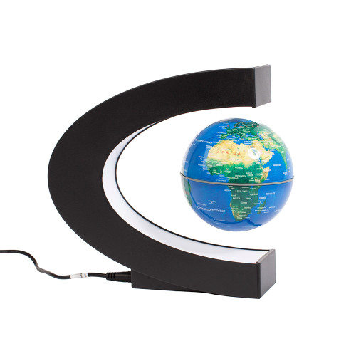 A blue world globe floats magnetically inside an illuminated, C-shaped black stand, showing Africa and the Atlantic Ocean.