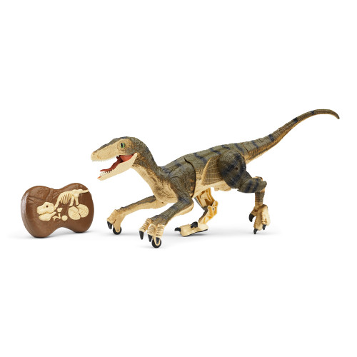 A green and tan remote controlled dinosaur raptor stands mid-stride, mouth open, beside its fossil-themed remote control.