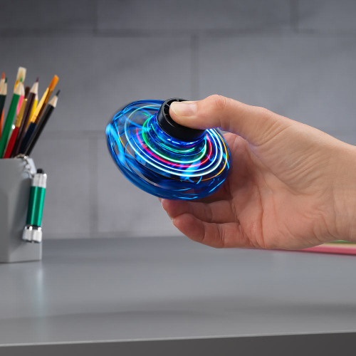 The blue LED Vortex Spinner held in a hand, spinning to create vivid, multi-coloured rings of light.