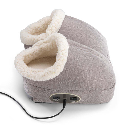 The grey fabric Wellbeing vibrating foot massager with its plush, cream-coloured sherpa lining and front controls plugged in.