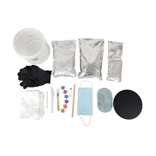 A flat lay of the Hand Moulding Kit contents including bucket, powder bags, gloves, paints, brushes, and a round black base.