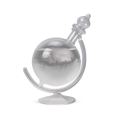 The Globe Storm Glass, a glass orb on a curved stand, with feathery white crystals forming inside the clear liquid.