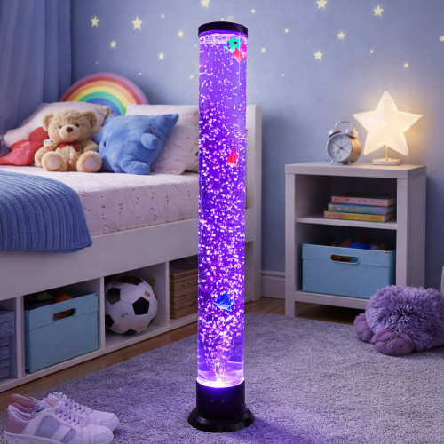A tall Bubble Fish Tower glows with purple light in a child's bedroom, with colourful fish floating amongst the bubbles.