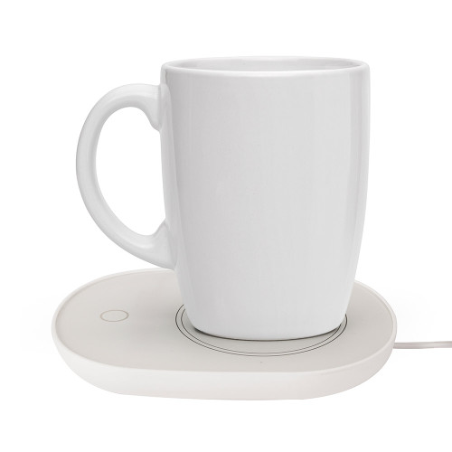 A white ceramic mug sits on the InGenious USB Cup Warmer, a white oval plate designed to keep drinks warm.