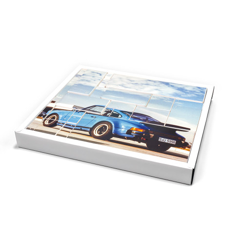 The Porsche 911 Turbo advent calendar box, featuring a photo of a classic blue model divided into 24 numbered doors.