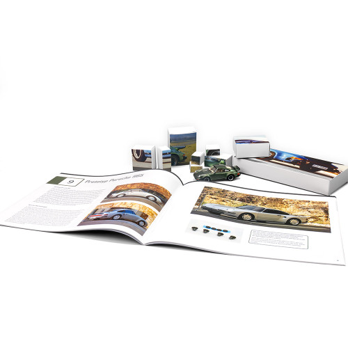 The Porsche 911 Turbo advent calendar displayed with an open book, a partially built green model, and its component boxes.