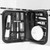 An open 10-piece grooming kit in its black carry case, resting against a tiled bathroom wall. Photographed in black and white.