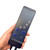 A hand holds the black remote for the Wellbeing Massage Mat, showing control buttons for heat, intensity, and massage zones.