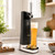 The Fizzics DraftPour beer tap on a kitchen worktop with a freshly poured pint of beer on its tray beside bowls of snacks.