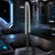 The Mandalorian Dark Saber desk light stands on a spaceship console, its black blade glowing with a crackled white light.