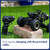 A black Rock Crawler RC truck with large tyres sits on a brick in the grass. It charges with the provided cable.