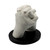 A detailed white cast from a hand moulding kit showing two hands clasped together, mounted on a circular black display stand.