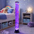 A tall Bubble Fish Tower glows with purple light in a child's bedroom, with colourful fish floating amongst the bubbles.