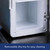 Close-up of the mini fridge's empty white interior, highlighting the clear removeable drip tray at the bottom for cleaning.