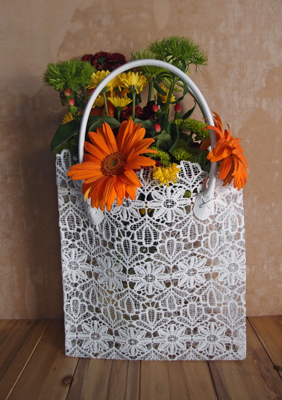 This stylish lace bag measures 10 1/2"W x 4"D x 11"H. Stands 17" tall including the vinyl covered handles. Made with stiffened lace.