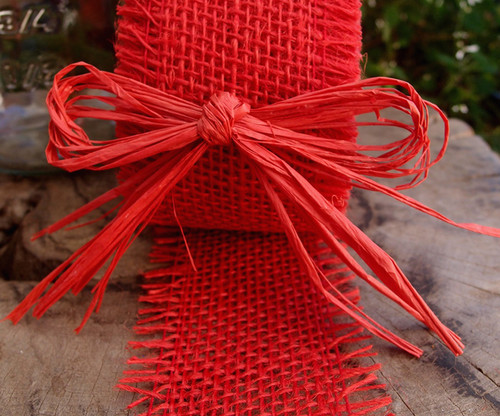 Overhead shot of multiple simple, lidded boxes tied with red raffia ribbon  bows and string. One has a blank tag for your message. Oak plank table bel  Stock Photo - Alamy