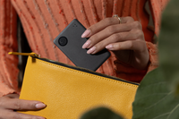 Image of Tile Slim- Black being placed into a yellow bag
