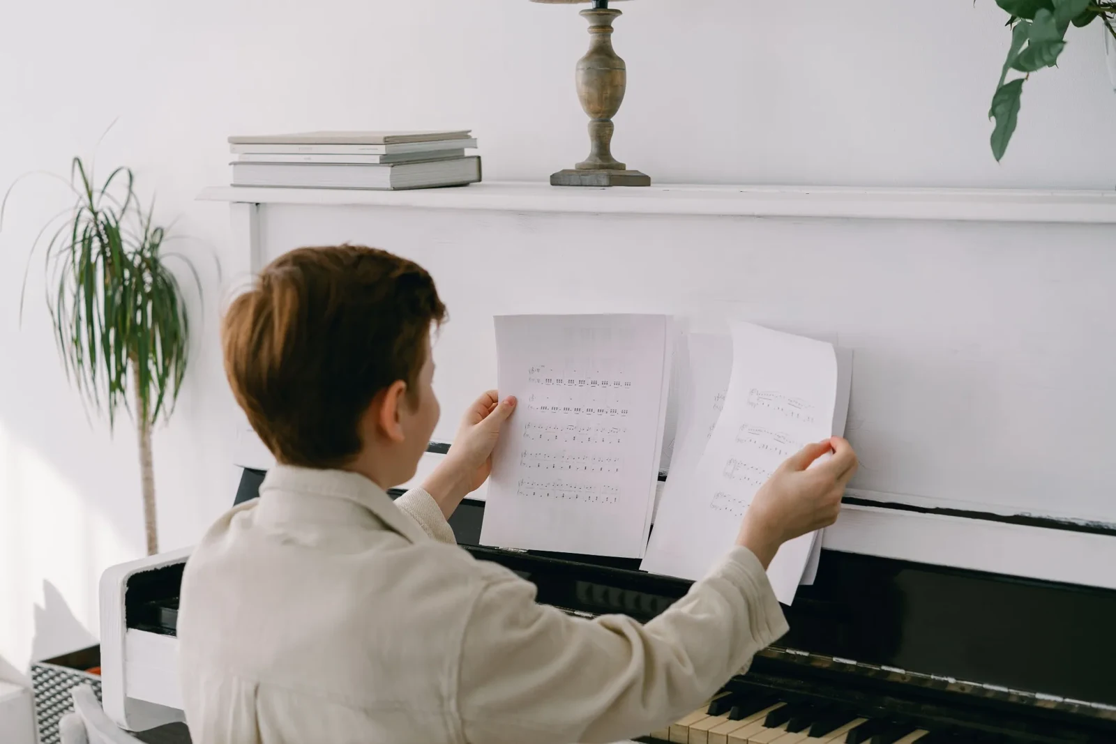 A young pianist practicing with sheet music