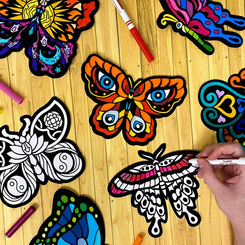 Hand coloring fuzzy velvet butterfly cutouts with markers