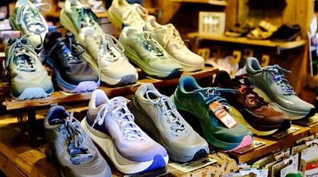 Customer receiving footwear fitting assistance at Pack & Paddle