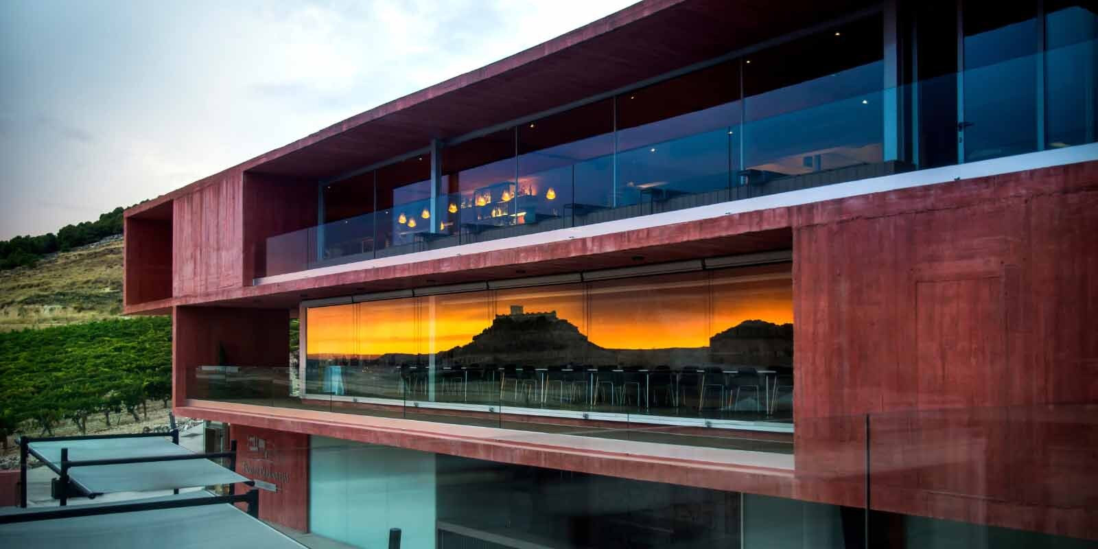 A photo of Pago de Carraovejas' modern winery with it's tasting and event space looking over their Ribera del Duero vineyards