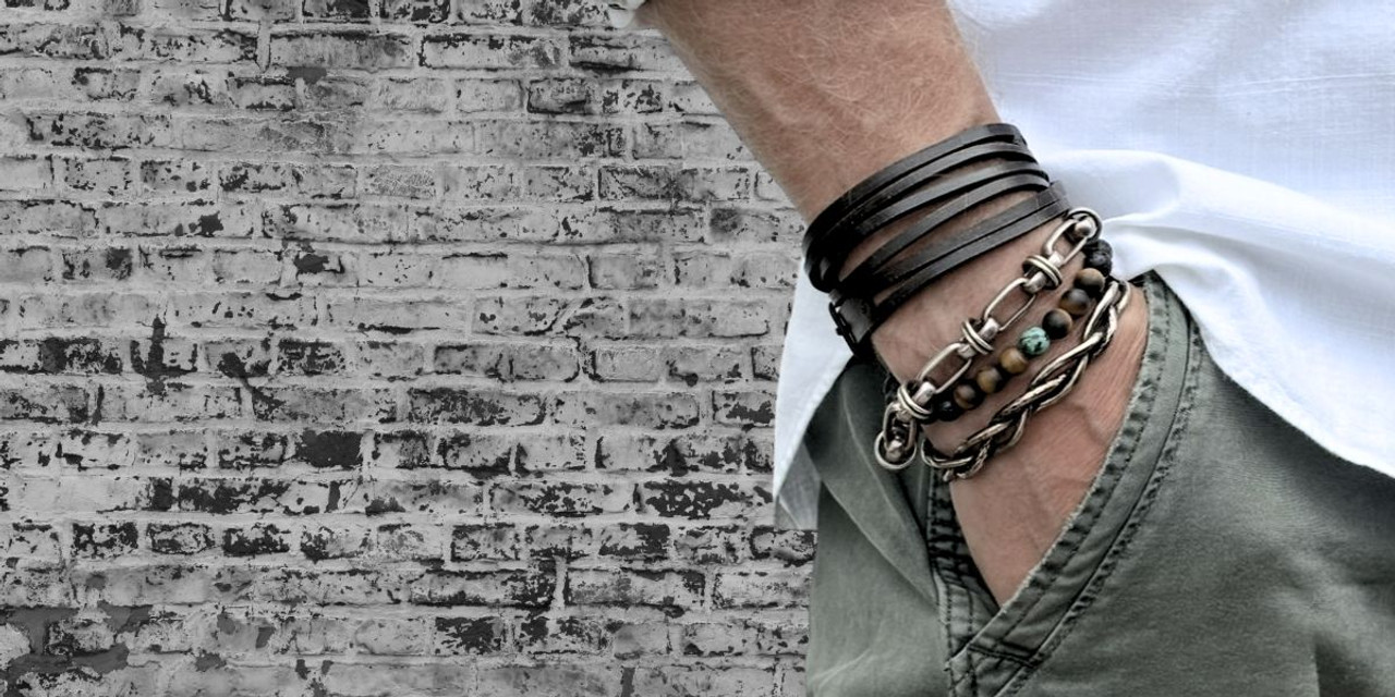 Man wearing handmade leather stacking bracelets with casual style.