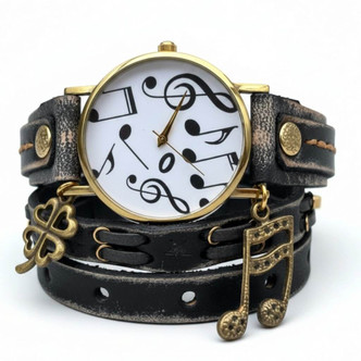 Front view of one-of-a-kind women's black leather wrap watch featuring 37mm musical-note dial, gold-tone accents, and decorative charms.