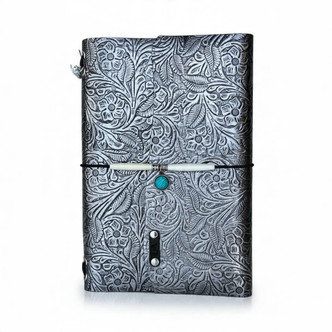 Moonlit Garden A5 refillable leather journal with metallic floral design, decorative elastic closure, and turquoise-colored charm.
