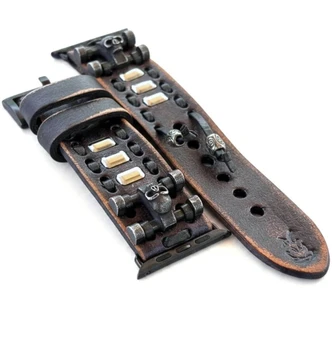 Close-up of distressed black leather Apple Watch straps with metal skull ornaments, decorative lacing and silver-tone accents