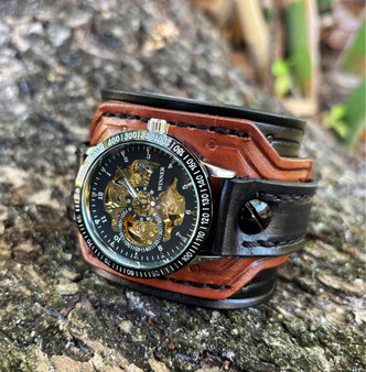 Steampunk watch movement with visible gears and mechanical details on leather cuff