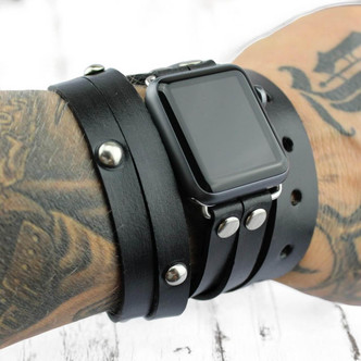 Black leather wrap apple watch band for men styled on wrist.