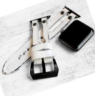 Distressed white leather Apple Watch strap with black hardware.