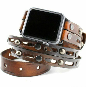 Brown leather wrap band for apple watch with layered bracelet design.