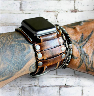 The Outrider 2 inch wide leather Apple Watch cuff, shown on wrist with Apple Watch face